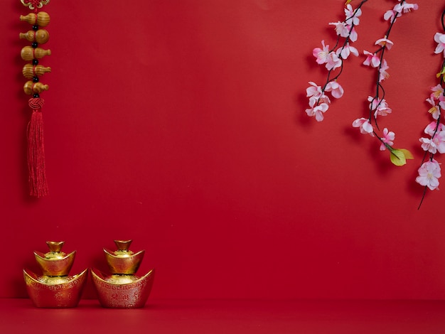 Chinese New Year. Flowers and chinese gold ingot