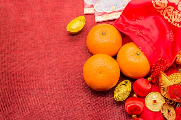 Chinese New Year, Orange and China gold ingots,  Traditional Asian style (Foreign text means blessing and lucky) with copy space for text