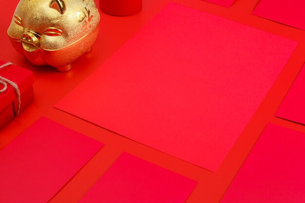 Chinese new year red packet and gold piggy bank on a red background Asian culture