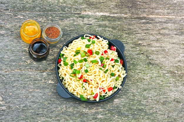 Chinese noodles in a cast iron bowl. Hot Chinese noodles.