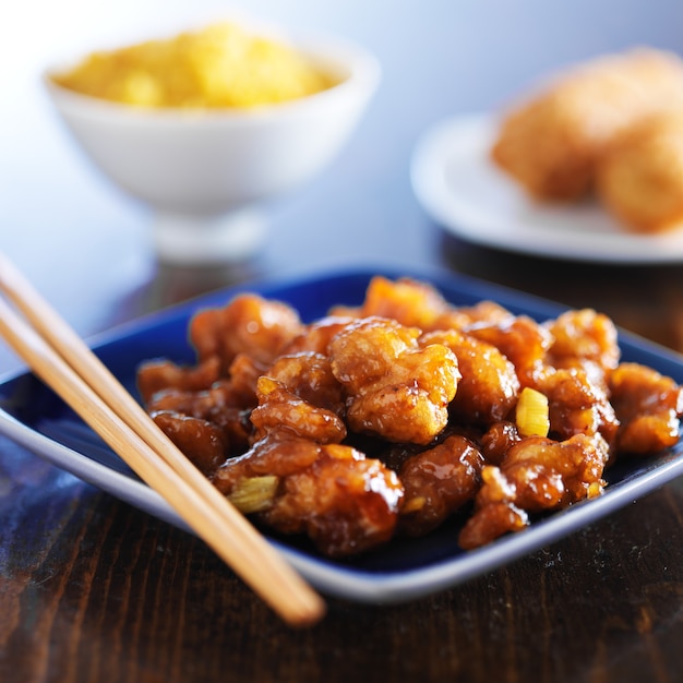 Chinese orange chicken on a blue plate