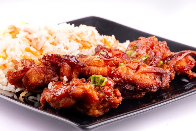 Photo chinese oriental food dish with rice and teriaky fried chicken isolated on white background close up