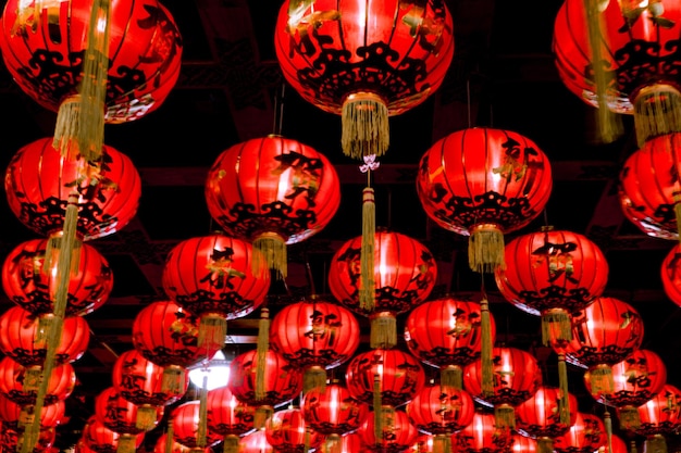 Chinese red lanterns hanging in street at night for decoration. Chinese letter written mean good luck.