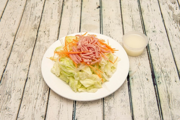 Chinese salad with iceberg lettuce grated carrots lots of grated cooked ham and strips of clear Chinese noodles