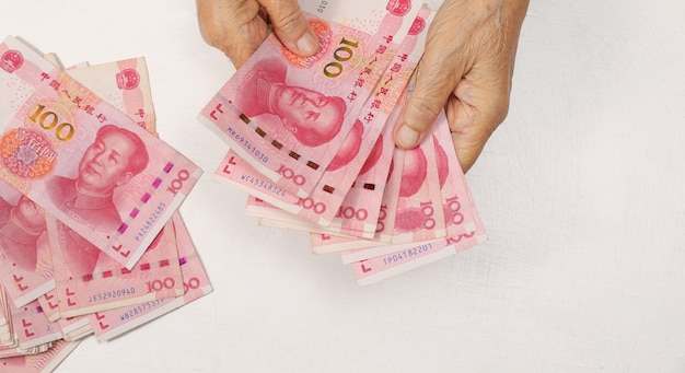 Chinese Senior woman counting money for payment