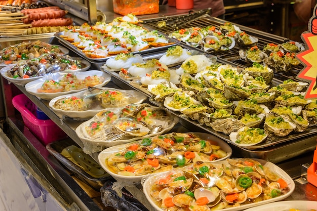 Chinese street food. Street trading. Chinese kinds of fresh seafood at an asian seafood market in Sanya, Hainan province, China. Inscription: name food.