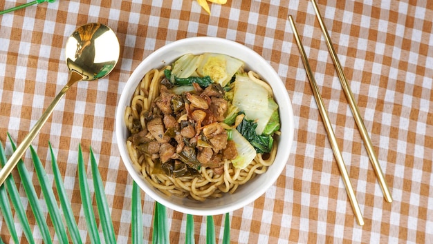 Chinese style chicken fried noodles with veggies Flat Lay