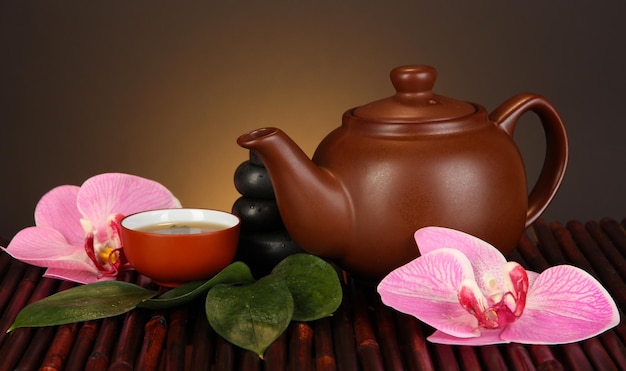 chinese tea ceremony on bamboo table on brown background