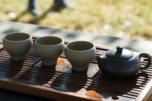 Chinese tea ceremony Ceramic teapot made of clay and bowls on a wooden background