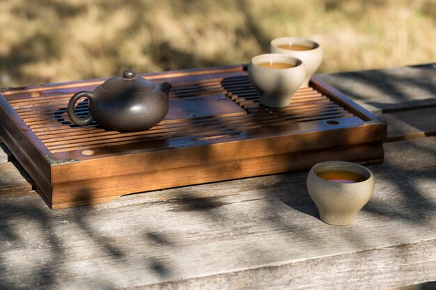 Chinese tea ceremony Ceramic teapot made of clay and bowls on a wooden background