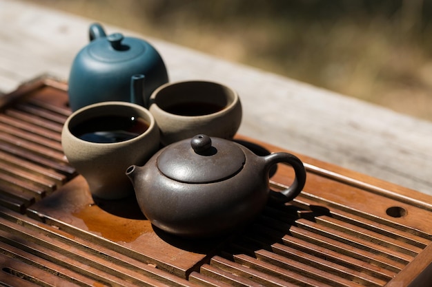 Chinese tea ceremony Ceramic teapot made of clay and bowls on a wooden background