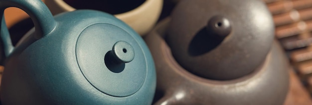 Chinese tea ceremony Ceramic teapot made of clay and bowls on a wooden background