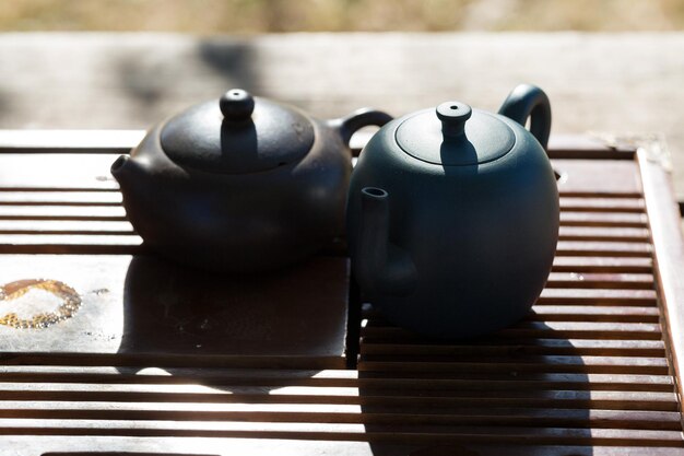 Chinese tea ceremony Ceramic teapot made of clay and bowls on a wooden background