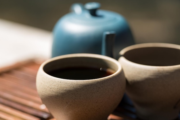 Chinese tea ceremony Ceramic teapot made of clay and bowls on a wooden background