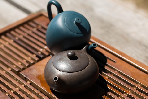 Chinese tea ceremony Ceramic teapot made of clay and bowls on a wooden background