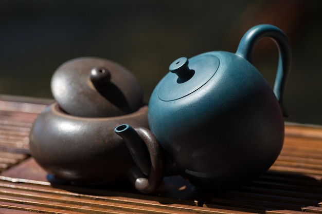 Chinese tea ceremony Ceramic teapot made of clay and bowls on a wooden background