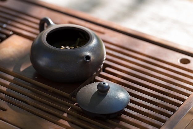 Chinese tea ceremony Ceramic teapot made of clay and bowls on a wooden background