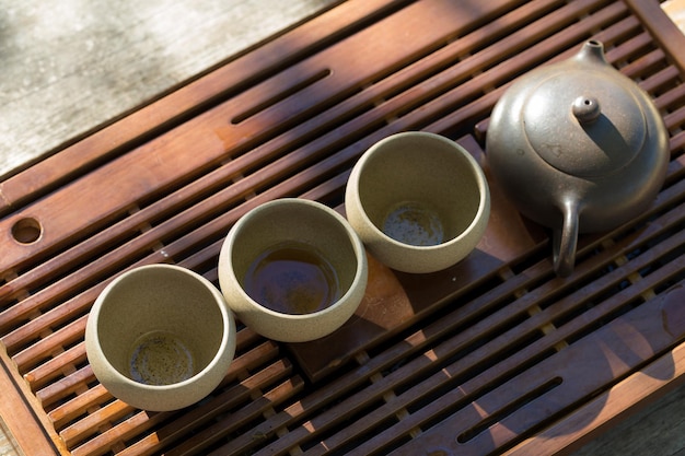 Chinese tea ceremony Ceramic teapot made of clay and bowls on a wooden background