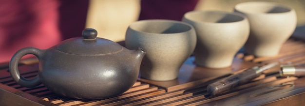 Chinese tea ceremony Ceramic teapot made of clay and bowls on a wooden background