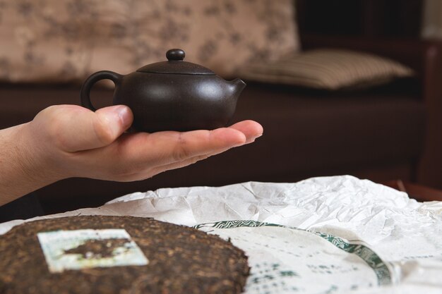 Chinese tea ceremony. Ceramic teapot made of clay and bowls on a wooden background.