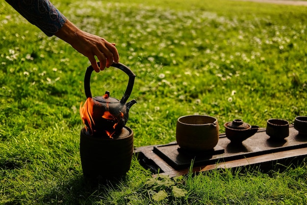 Chinese tea ceremony in a park. Tea drinking in the open air.