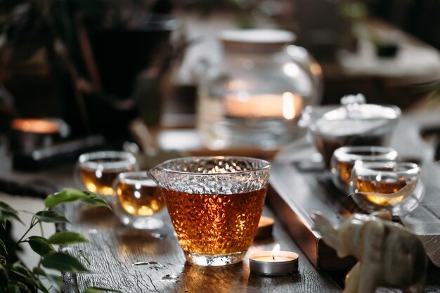 Chinese tea ceremony with candle flame decoration on a dark\
background