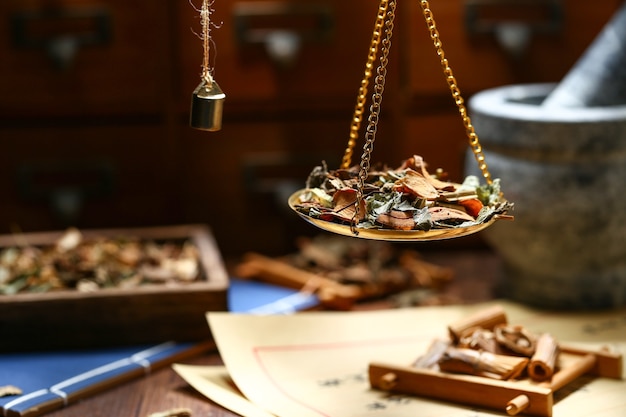 Photo chinese traditional herbal medicine in steelyard. translation reads as chinese herbal therapy.