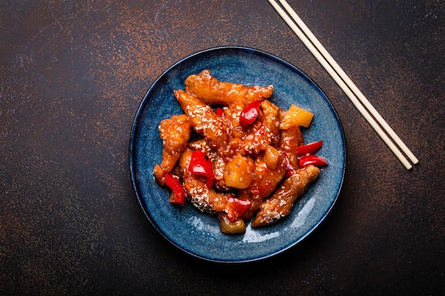 Chinese traditional wok dish sweat and sour deep fried chicken with vegetables stirfry on plate