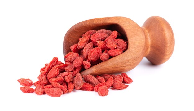 Chinese wolfberries in wooden scoop isolated on white background heap of dried goji berry