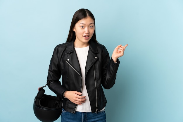 Chinese woman holding a motorcycle helmet isolated