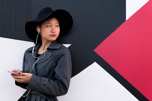 Chinese woman listening music with earphones