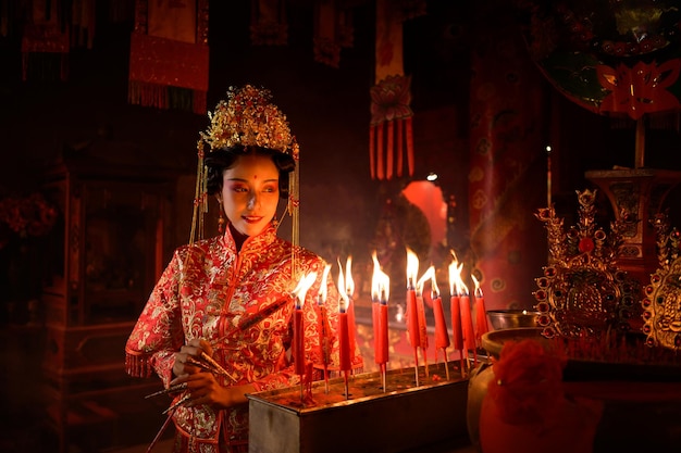 Chinese woman make wishes pray and light candles On the occasion of the annual Chinese New Year