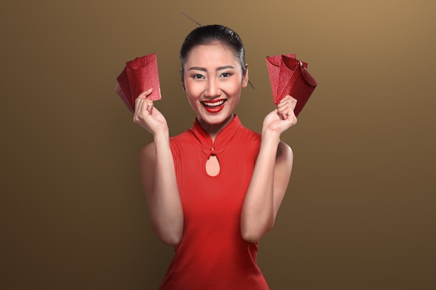 Chinese woman in tradional clothing holding angpao