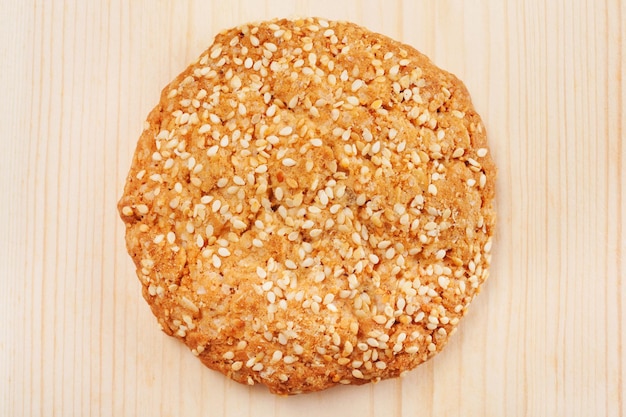 Chip cookies with sesame seeds on wooden board