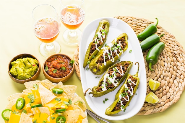 Chipotle beef & bean stuffed chili peppers garnished with sour cream and scallions.