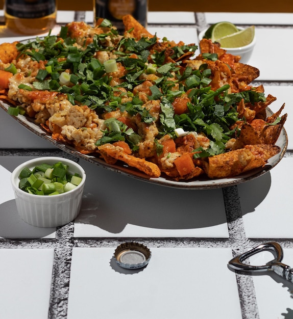 Chipotle Chicken Nachos with green onions and cilantro