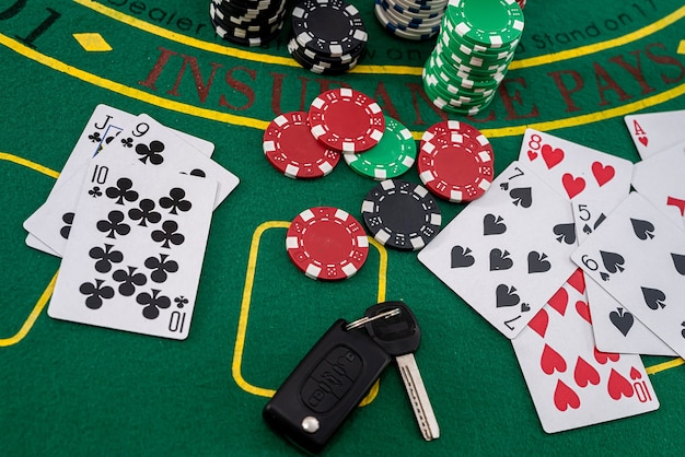 Chips and cards for playing poker with risky bet with car key. casino