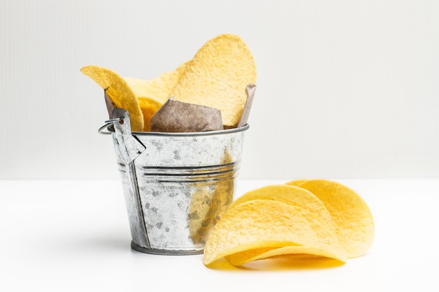 Chips in a galvanized bucket on a white table