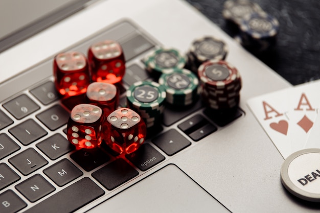 Photo chips red dices and playing cards with aces for poker online or casino gambling closeup