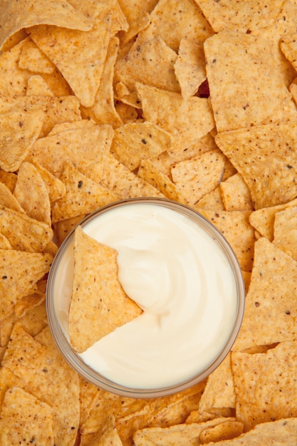 Chips surrounding a  bowl of dip