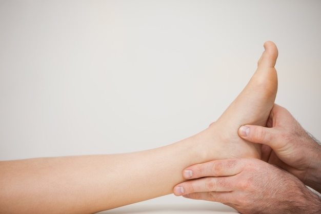 Chiropodist examining the foot of a patient