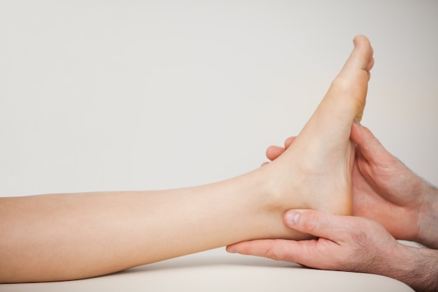 Chiropodist holding the foot of a patient