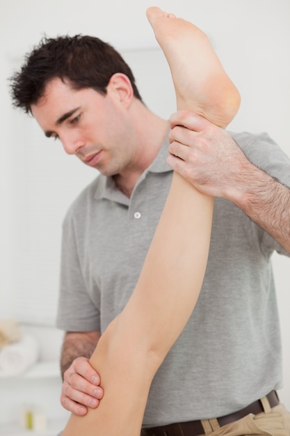 Chiropractor extending the leg of a patient