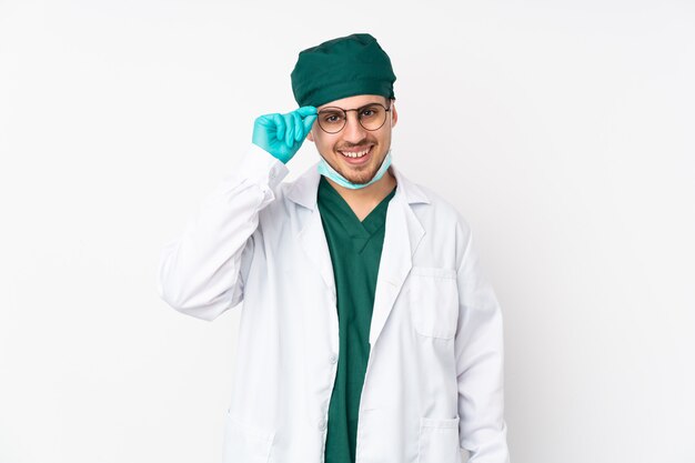 Chirurg in groen uniform op wit met een bril en gelukkig