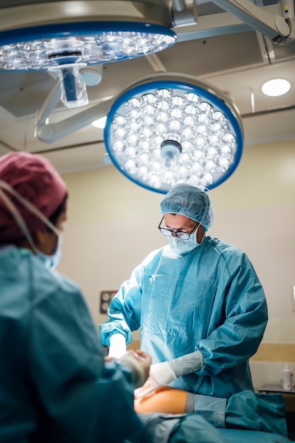 Chirurgen en verpleegster tijdens een operatie