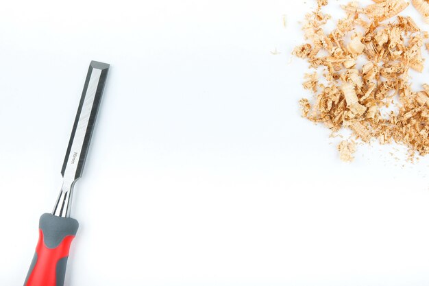 chisel and wooden shavings on a white background