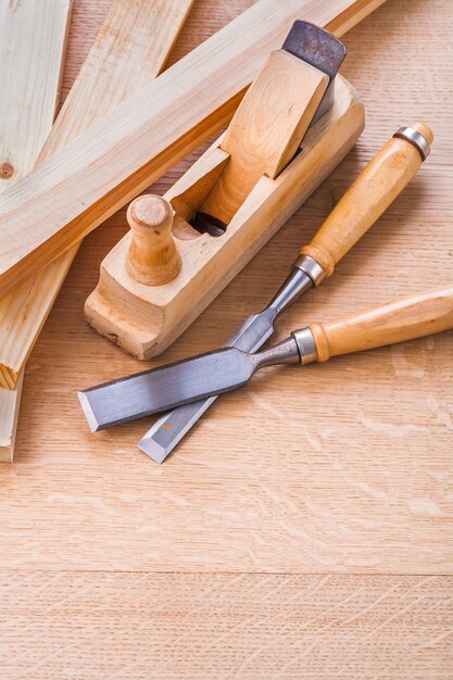 Photo chisels and woodworkers plane on wooden board