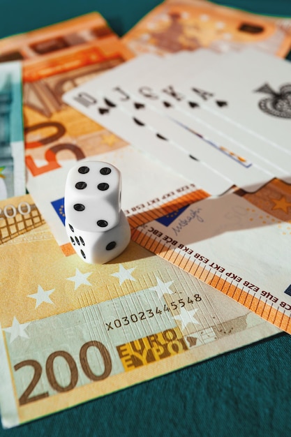 Chisinau, Moldova - 20. 12. 2020 dice, playing cards on a green cloth in a casino dollars and euro bills