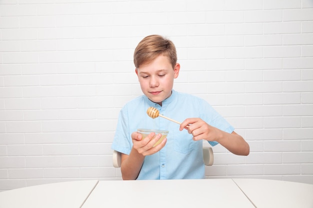 Chisinau, MOLDOVA - 29 June 2022. European teenager is tasting honey