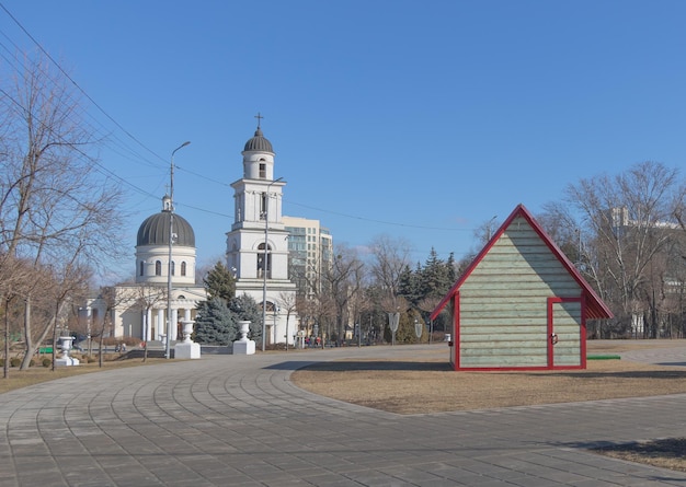 Chisinau Moldova December 25 2021 A church and a small wooden house located in the center of Chisinau the Cathedral with the blue sky in winter time